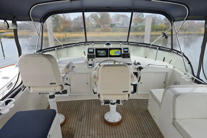 Halcyon Yacht Photos Pics Grand Banks 46 Europa 2005 yacht helm with navigation equipment and seating.