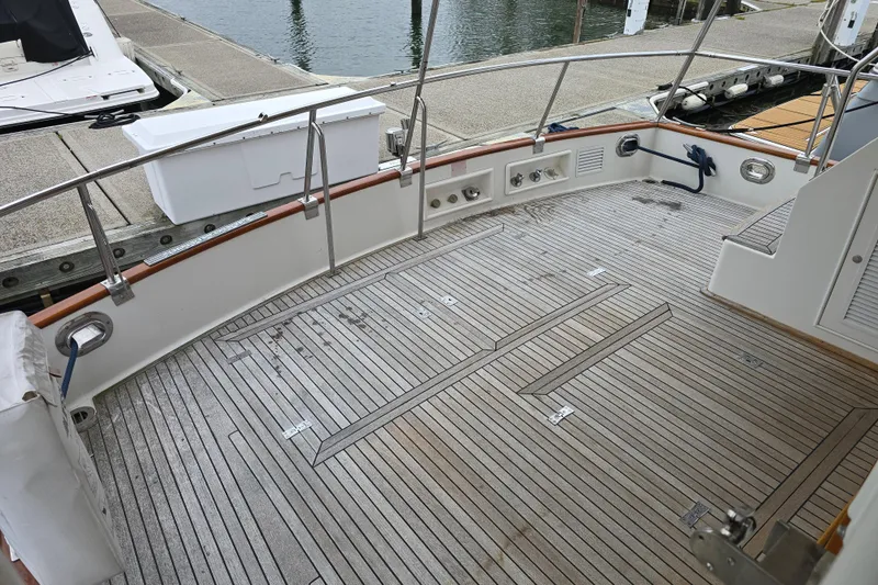 Halcyon Yacht Photos Pics Grand Banks 46 Europa 2005 yacht deck with teak flooring at marina.
