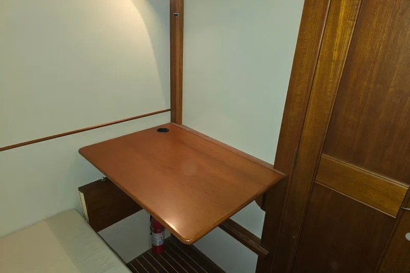 Halcyon Yacht Photos Pics Interior of 2005 Grand Banks 46 Europa with wooden foldable table and fire extinguisher.