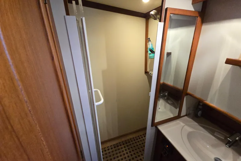 Halcyon Yacht Photos Pics Bathroom interior of 2005 Grand Banks 46 Europa yacht, featuring shower and sink.