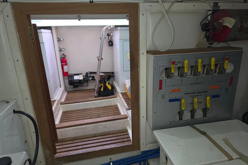 Halcyon Yacht Photos Pics Engine room of 2005 Grand Banks 46 Europa with control panel and fire extinguisher.