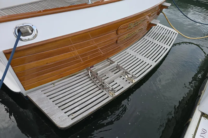 Halcyon Yacht Photos Pics Grand Banks 46 Europa 2005 yacht stern with wooden swim platform.