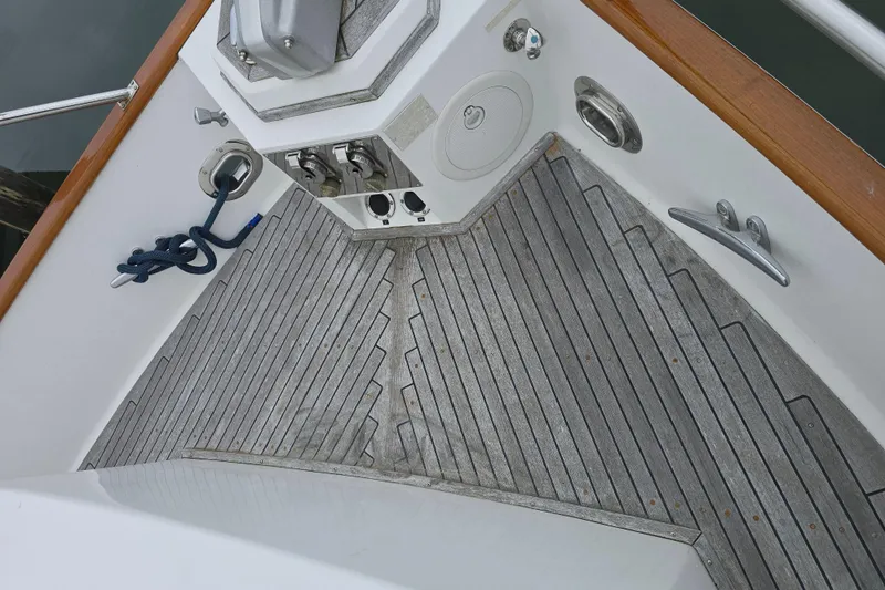 Halcyon Yacht Photos Pics Deck of 2005 Grand Banks 46 Europa yacht with teak flooring and mooring equipment.