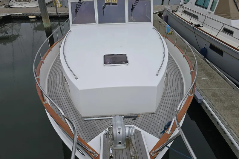 Halcyon Yacht Photos Pics 2005 Grand Banks 46 Europa yacht docked at marina, showcasing spacious deck.