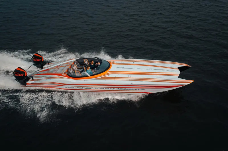  Yacht Photos Pics 2024 MTI 390X speedboat with dual engines cruising on open water.