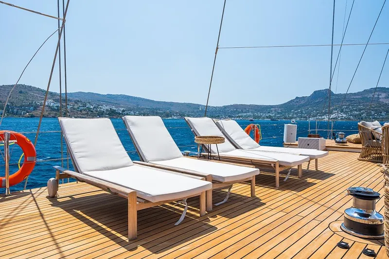 Yazz Yacht Photos Pics Sun loungers on the deck of a 2007 Aegean Yacht Schooner with scenic ocean views.