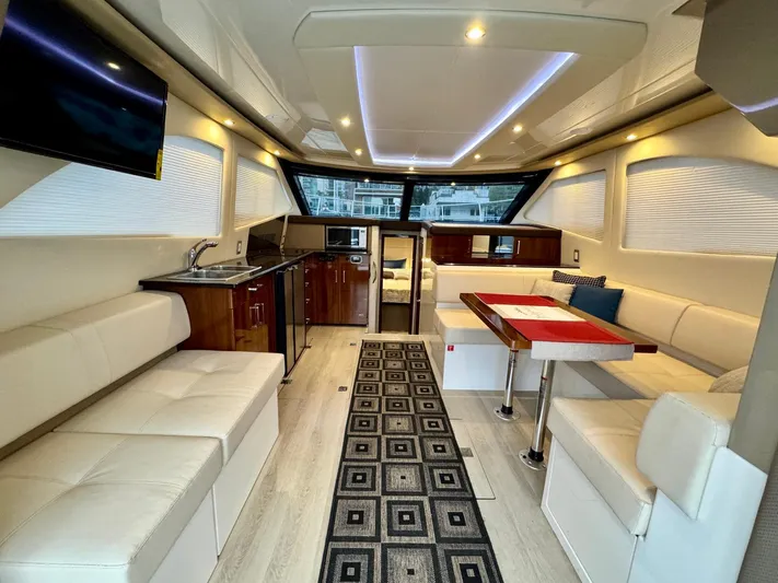  Yacht Photos Pics Luxurious interior of 2016 Carver C40 Command Bridge yacht with modern seating and dining area.