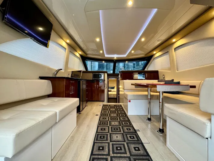  Yacht Photos Pics Luxurious interior of a 2016 Carver C40 Command Bridge yacht with modern seating and dining area.