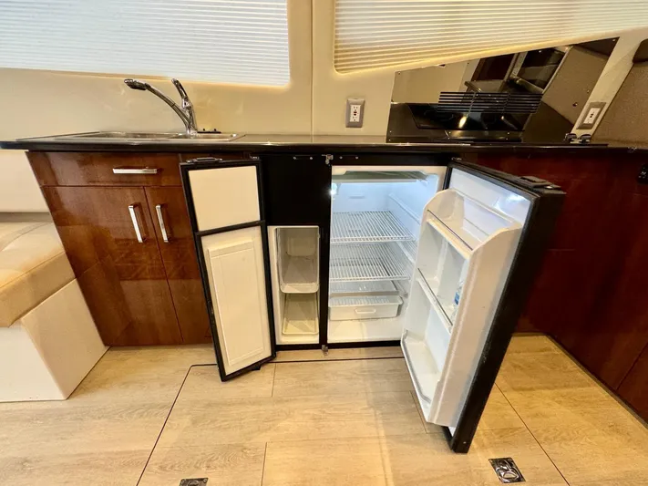  Yacht Photos Pics Modern kitchen in 2016 Carver C40 Command Bridge yacht with open fridge and wooden cabinets.