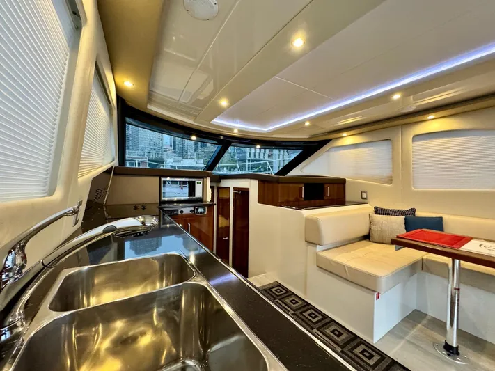  Yacht Photos Pics Interior of 2016 Carver C40 Command Bridge yacht with modern kitchen and seating area.