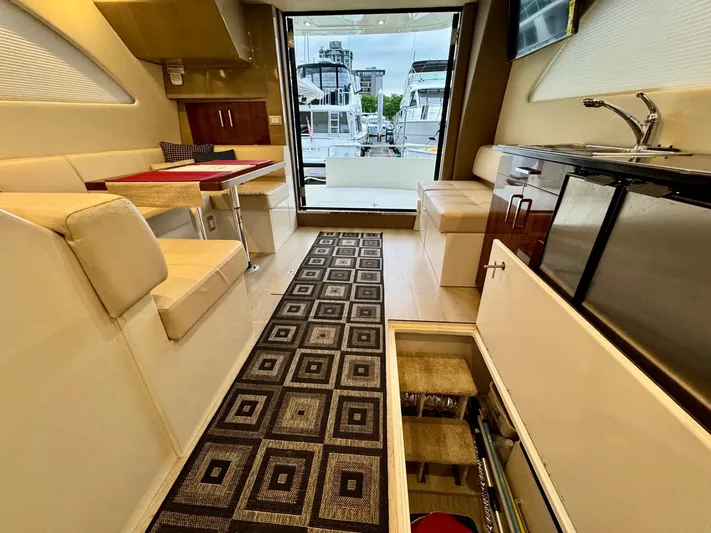  Yacht Photos Pics Interior of 2016 Carver C40 Command Bridge yacht with modern seating and kitchenette.