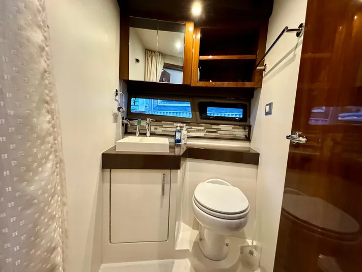 Yacht Photos Pics Bathroom interior of 2016 Carver C40 Command Bridge yacht, featuring modern fixtures and wood accents.