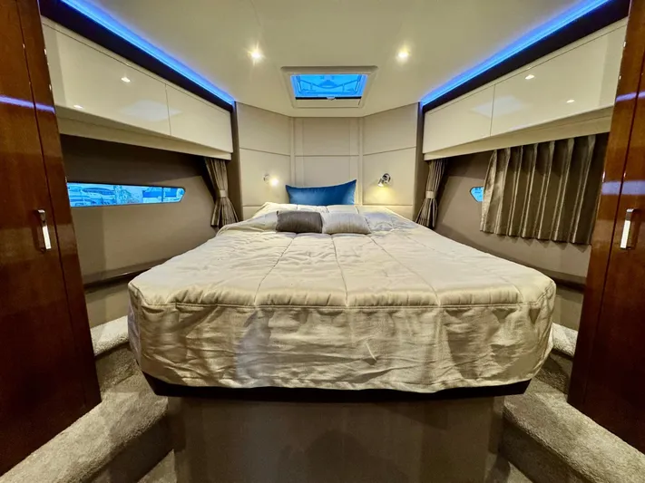  Yacht Photos Pics Luxurious bedroom interior of 2016 Carver C40 Command Bridge yacht with ambient lighting.