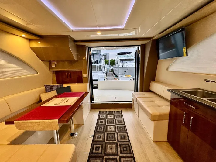  Yacht Photos Pics Luxurious interior of 2016 Carver C40 Command Bridge yacht with modern seating and kitchenette.