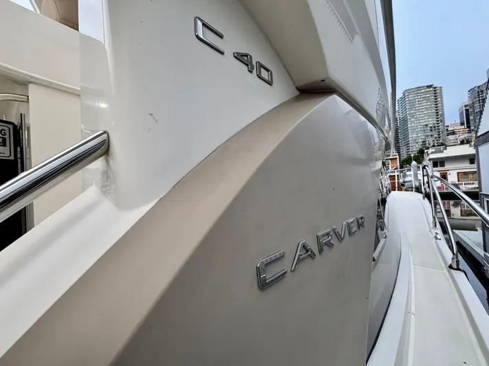  Yacht Photos Pics 2016 Carver C40 Command Bridge yacht, side view with cityscape background.