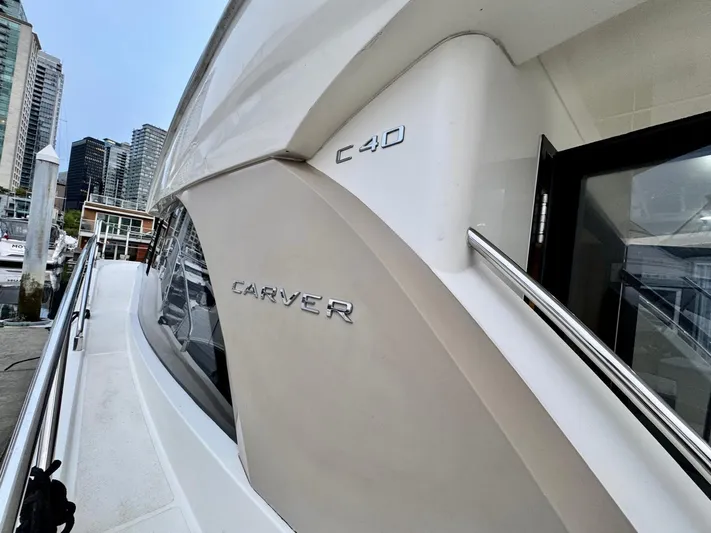  Yacht Photos Pics 2016 Carver C40 Command Bridge yacht docked in a marina, city skyline in background.
