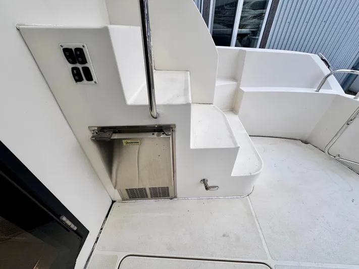  Yacht Photos Pics 2016 Carver C40 Command Bridge yacht stairs and deck area with stainless steel railing.