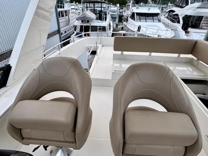  Yacht Photos Pics 2016 Carver C40 Command Bridge with beige seats, docked among other yachts.