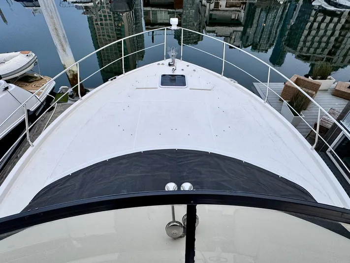  Yacht Photos Pics 2016 Carver C40 Command Bridge yacht docked in a marina, viewed from the bow.