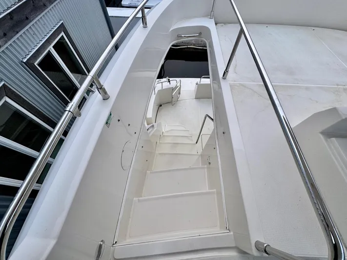  Yacht Photos Pics Stairway on 2016 Carver C40 Command Bridge yacht, featuring sleek design and stainless steel railings.