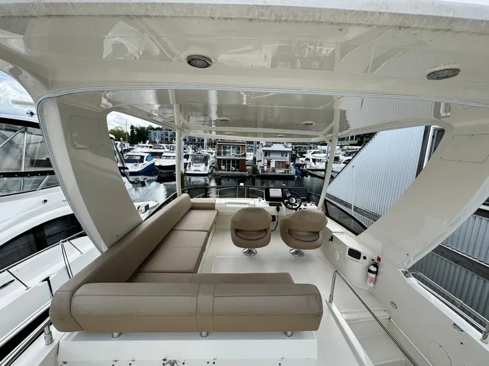  Yacht Photos Pics 2016 Carver C40 Command Bridge yacht interior with seating and helm, docked at marina.