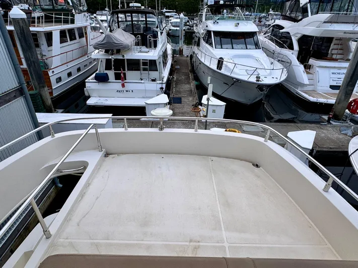  Yacht Photos Pics 2016 Carver C40 Command Bridge yacht docked among other boats at a marina.