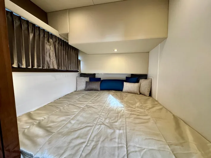  Yacht Photos Pics Cozy cabin bed in 2016 Carver C40 Command Bridge yacht with pillows and curtains.