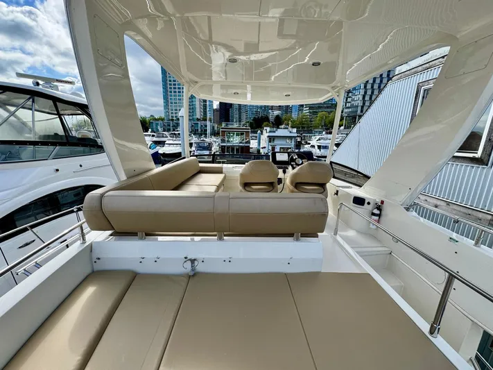  Yacht Photos Pics 2016 Carver C40 Command Bridge yacht interior with beige seating, docked at marina.
