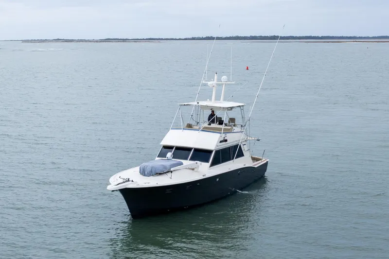  Yacht Photos Pics 1984 Hatteras 52 Convertible yacht cruising on calm waters.