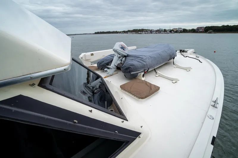  Yacht Photos Pics 1984 Hatteras 52 Convertible yacht on calm water, showcasing deck and equipment.