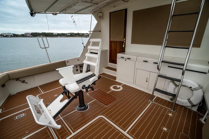  Yacht Photos Pics 1984 Hatteras 52 Convertible yacht deck with fishing chair and ladder.