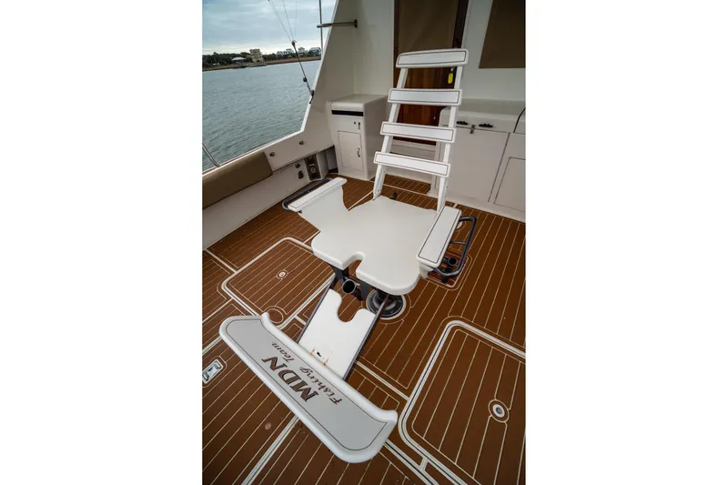  Yacht Photos Pics Fishing chair on 1984 Hatteras 52 Convertible yacht deck, overlooking water.
