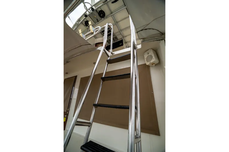  Yacht Photos Pics Ladder leading to upper deck of 1984 Hatteras 52 Convertible yacht.