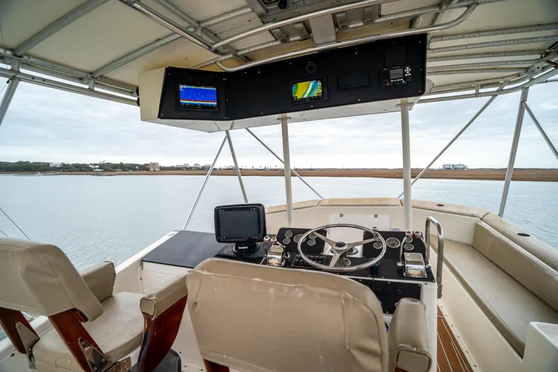  Yacht Photos Pics Helm of 1984 Hatteras 52 Convertible yacht with navigation equipment and panoramic water view.