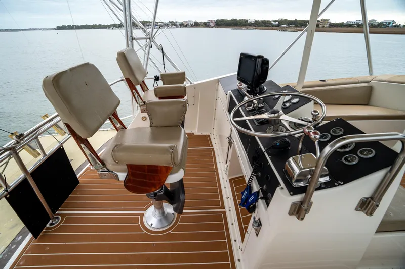  Yacht Photos Pics 1984 Hatteras 52 Convertible yacht helm with dual seats and steering wheel.