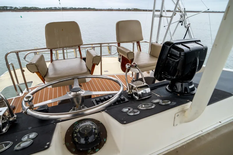  Yacht Photos Pics 1984 Hatteras 52 Convertible yacht helm with steering wheel and navigation equipment.