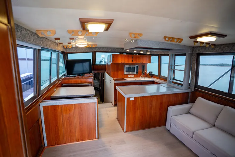  Yacht Photos Pics Interior of 1984 Hatteras 52 Convertible yacht with modern kitchen and seating area.