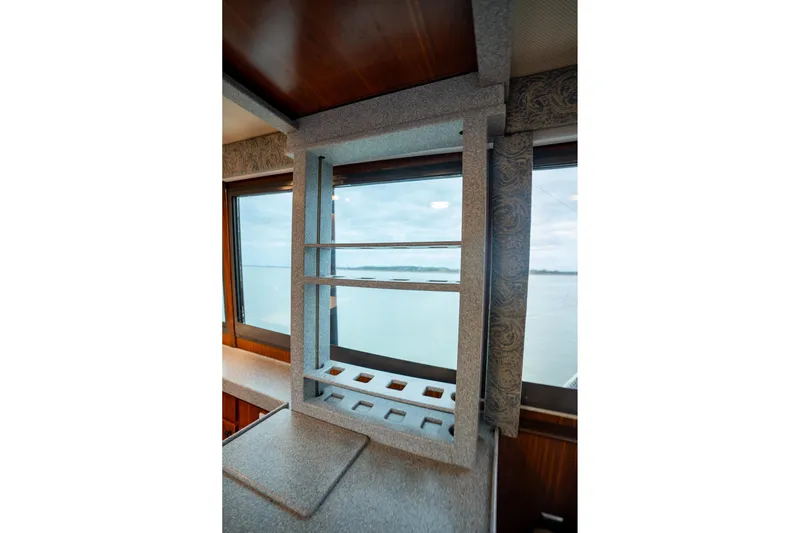 Yacht Photos Pics Interior of 1984 Hatteras 52 Convertible yacht with window view and shelving.