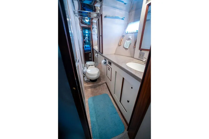  Yacht Photos Pics 1984 Hatteras 52 Convertible yacht bathroom with modern fixtures and blue accents.