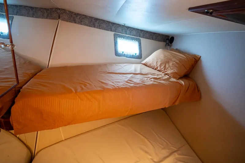 Yacht Photos Pics Cozy cabin interior of 1984 Hatteras 52 Convertible yacht with twin beds.
