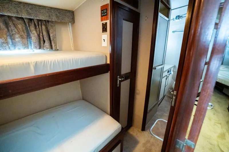  Yacht Photos Pics Interior of 1984 Hatteras 52 Convertible yacht with bunk beds and hallway view.