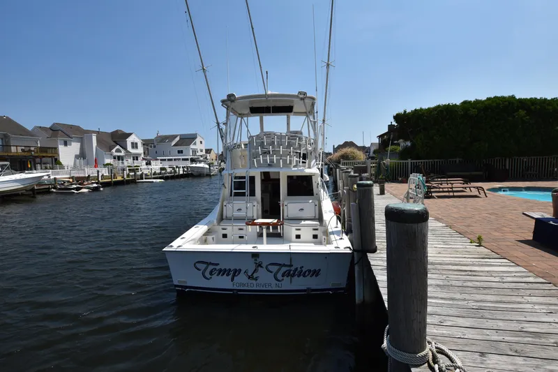  Yacht Photos Pics 1994 Cabo 35 Flybridge Sportfisher docked at a marina.