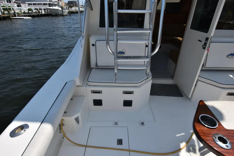  Yacht Photos Pics 1994 Cabo 35 Flybridge Sportfisher boat deck with ladder and seating.