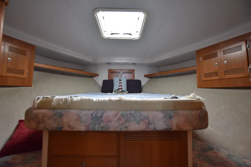  Yacht Photos Pics 1994 Cabo 35 Flybridge Sportfisher cabin interior with bed and storage cabinets.