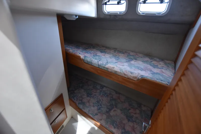  Yacht Photos Pics 1994 Cabo 35 Flybridge Sportfisher cabin with bunk beds and porthole windows.