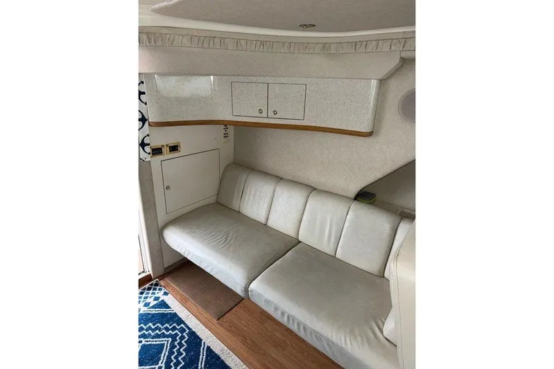  Yacht Photos Pics Interior of 1997 Sea Ray 400 Sedan Bridge with white leather seating and wooden accents.