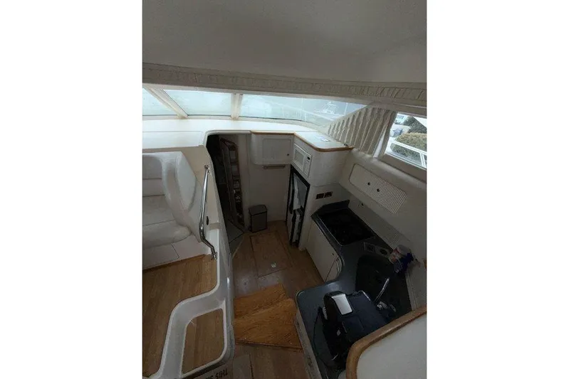  Yacht Photos Pics Interior of 1997 Sea Ray 400 Sedan Bridge yacht, featuring kitchen and seating area.