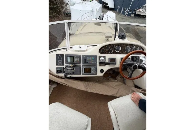  Yacht Photos Pics 1997 Sea Ray 400 Sedan Bridge helm with navigation instruments and wooden steering wheel.