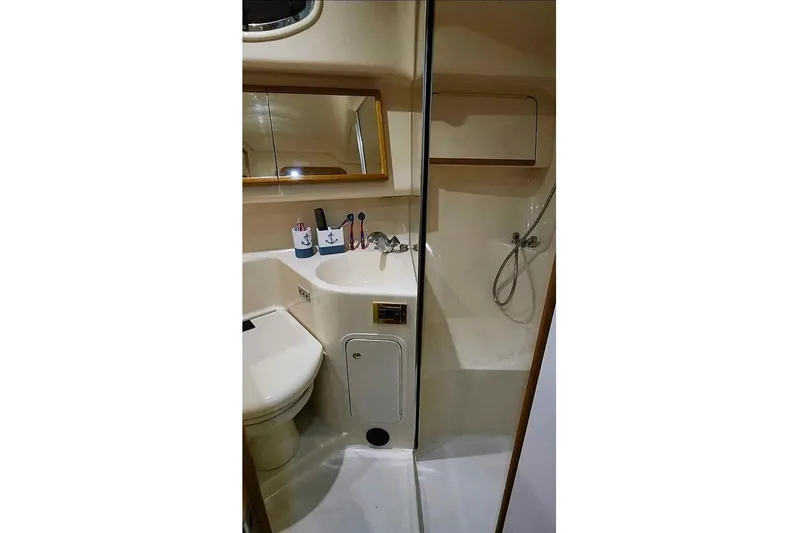  Yacht Photos Pics Bathroom interior of 1997 Sea Ray 400 Sedan Bridge yacht, featuring sink and shower.