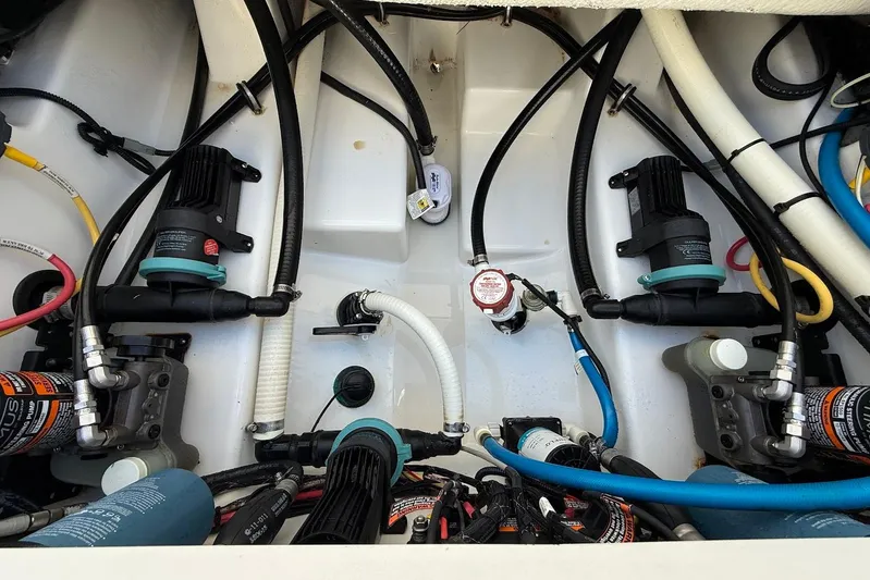  Yacht Photos Pics Engine compartment of a 2019 Blackfin 272 DC boat, showcasing pumps and hoses.